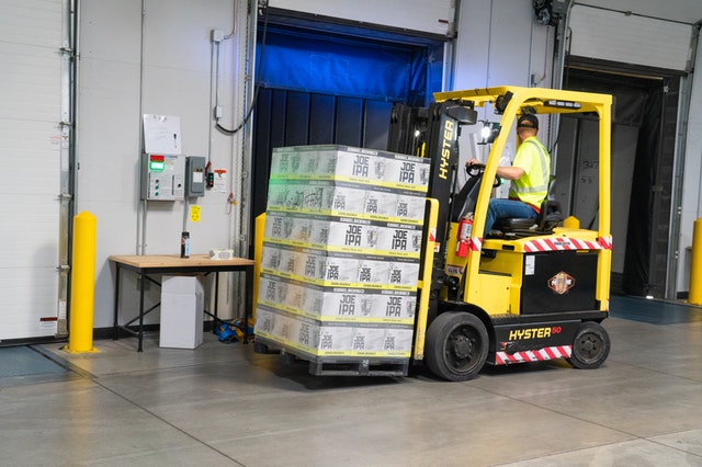 Man riding yellow forklift